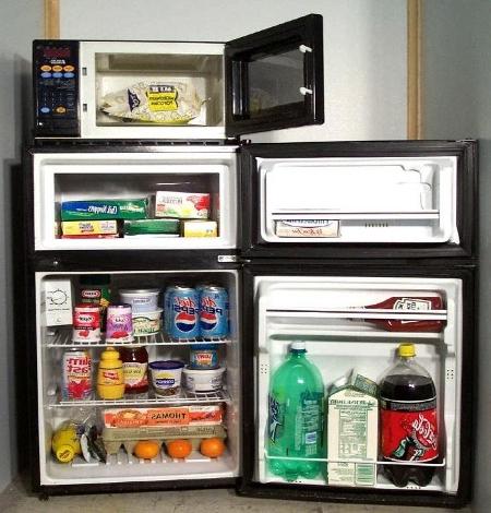 The inside of the microfridge stocked with food.